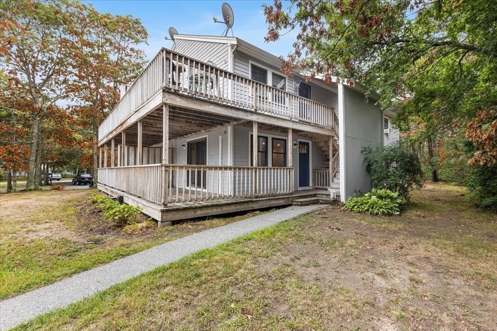 35 Ashumet Road, Unit 11B Mashpee, MA 02649 - Photo 4 of 24 a view of a house with a yard