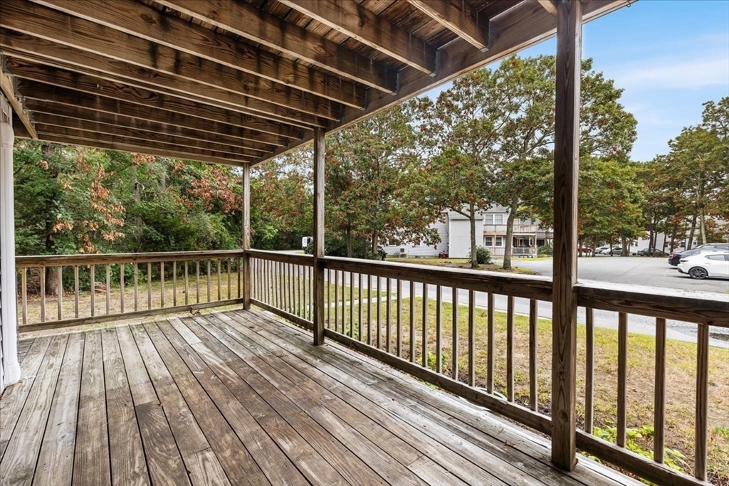 35 Ashumet Road, Unit 11B Mashpee, MA 02649 - Photo 7 of 24 a view of backyard with a deck and wooden floor
