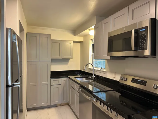 a kitchen with a sink stove and microwave