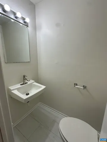 a bathroom with a sink mirror and toilet