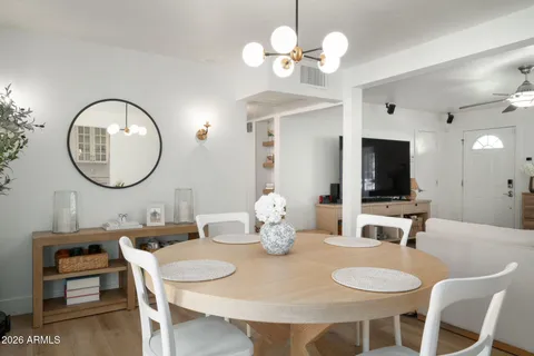 a view of a dining room with furniture and a chandelier