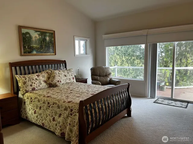 a bedroom with a bed and glass window