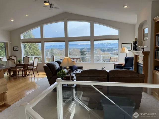 a living room with furniture and floor to ceiling windows