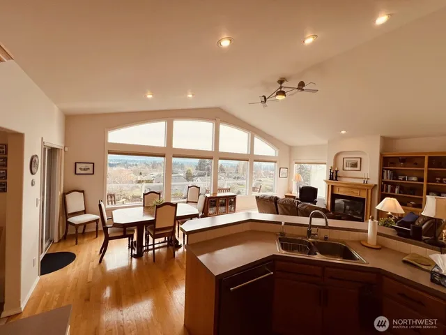 a living room with lots of furniture and a large window