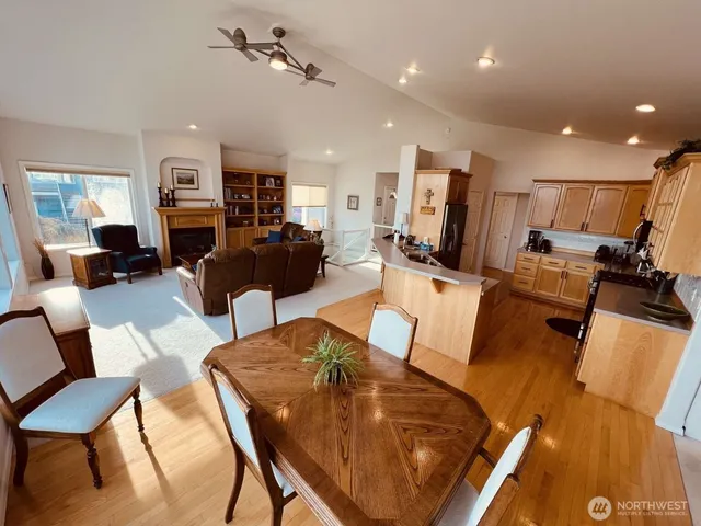 a living room with furniture kitchen view and a flat screen tv