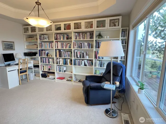 a work room with furniture cabinets and a floor to ceiling window