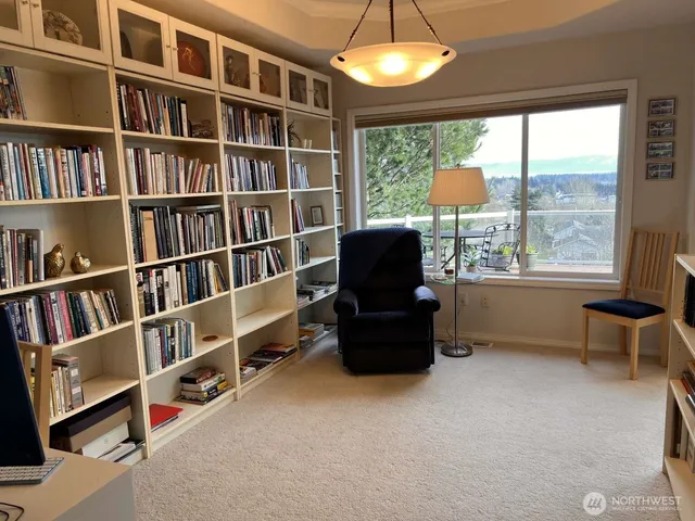 a living room with furniture and a book shelf