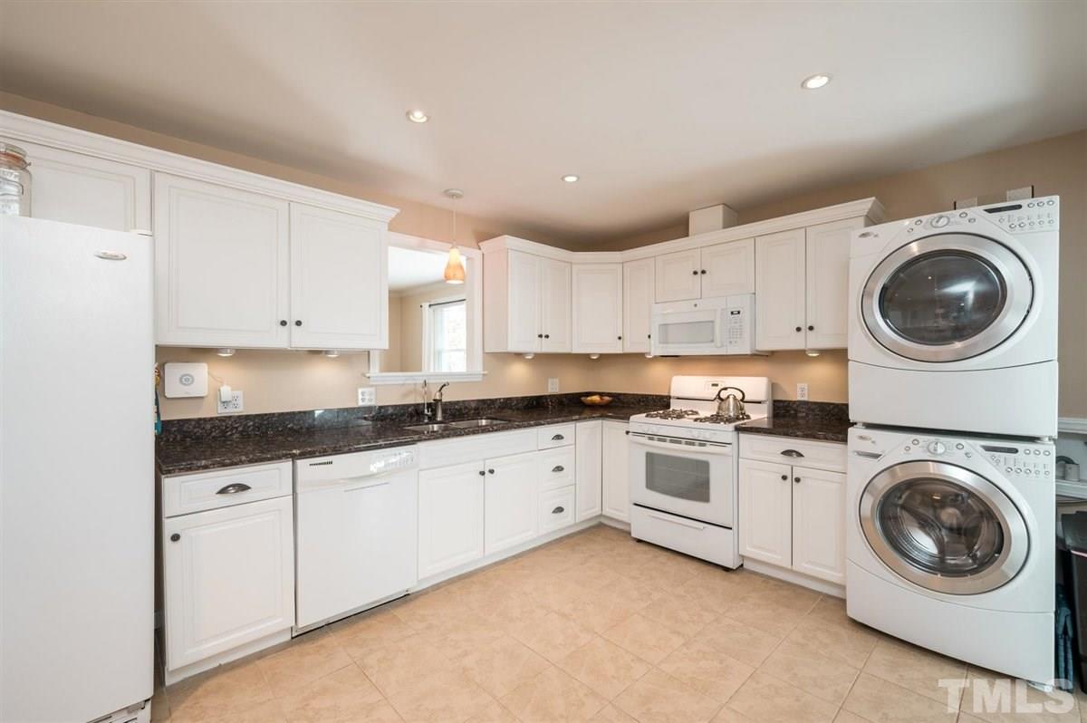 2213 Mossbank Road Raleigh, NC 27604 - Photo 13 of 28 a kitchen with granite countertop white cabinets and white stainless steel appliances