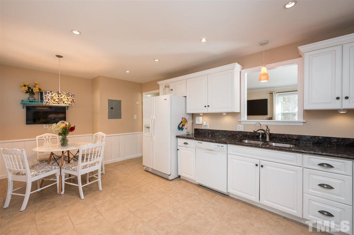 2213 Mossbank Road Raleigh, NC 27604 - Photo 14 of 28 a kitchen with granite countertop a sink and white cabinets