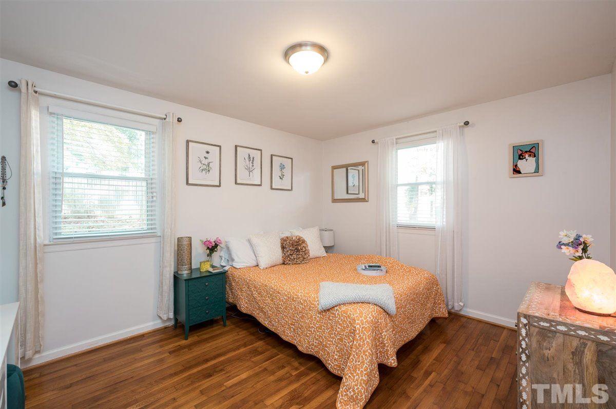2213 Mossbank Road Raleigh, NC 27604 - Photo 18 of 28 a bedroom with a bed and wooden floor