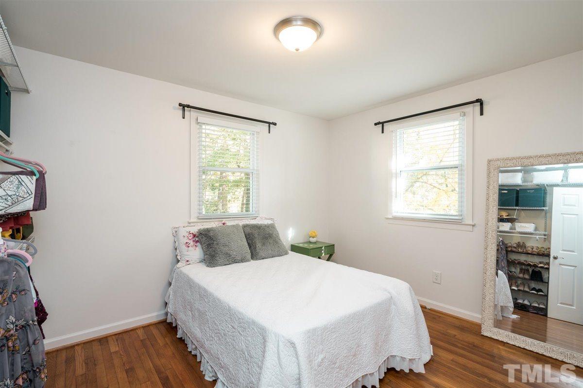 2213 Mossbank Road Raleigh, NC 27604 - Photo 20 of 28 a bedroom with a bed and wooden floor