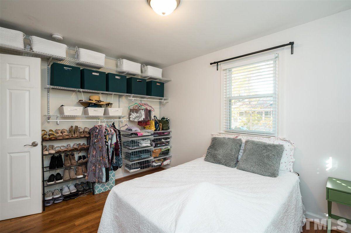 2213 Mossbank Road Raleigh, NC 27604 - Photo 21 of 28 a bedroom with a bed a mirror and dresser