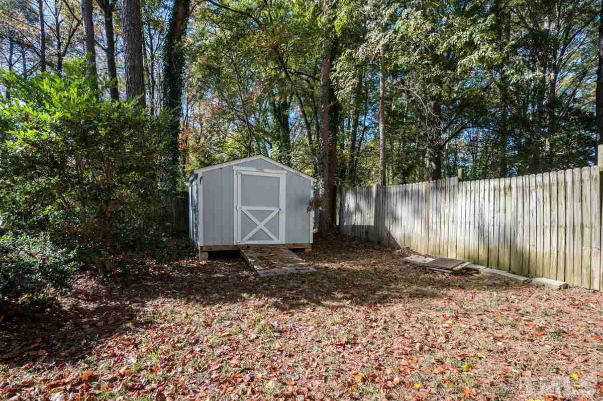 2213 Mossbank Road Raleigh, NC 27604 - Photo 26 of 28 a backyard of a house with lots of green space