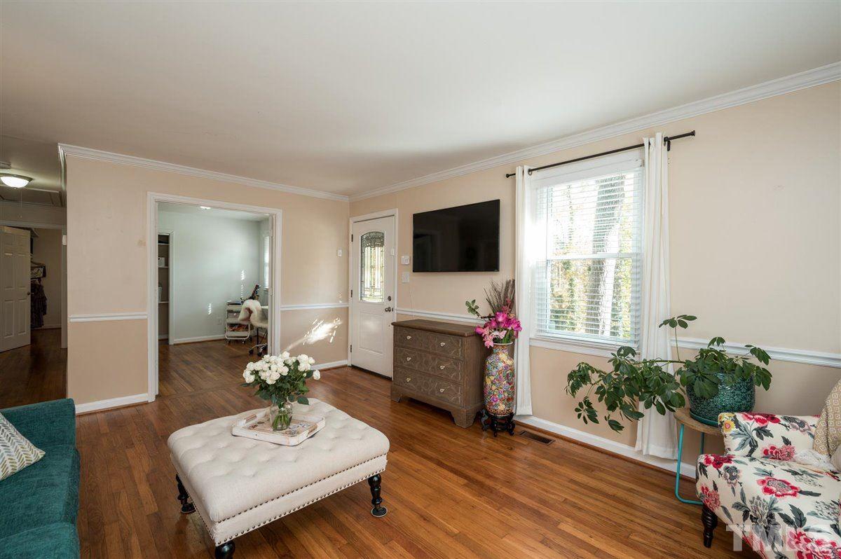 2213 Mossbank Road Raleigh, NC 27604 - Photo 7 of 28 a living room with furniture a flat screen tv and a window