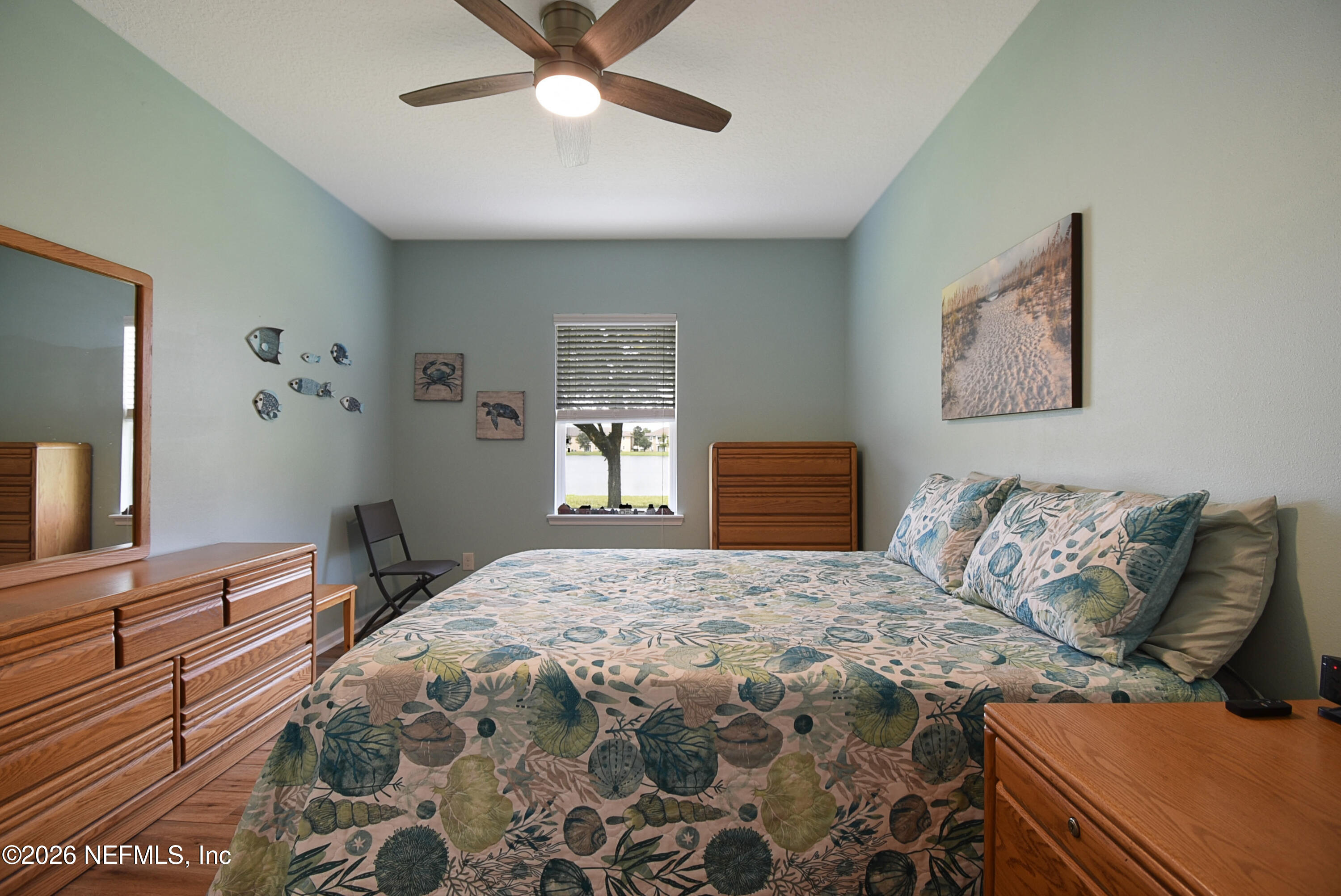2334 Golden Lake Loop St. Augustine, FL 32084 - Photo 11 of 31 a bedroom with a large bed and a chandelier