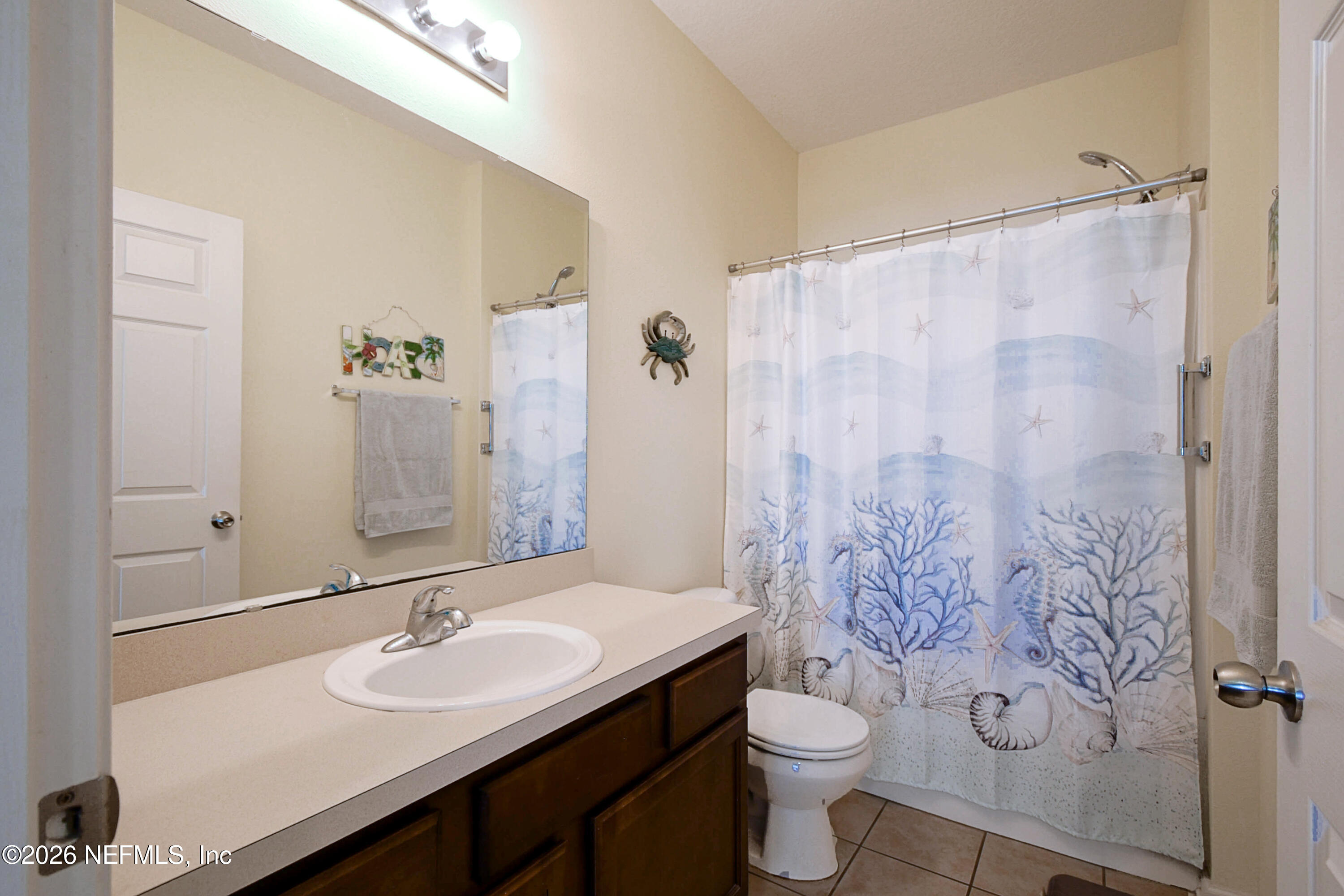 2334 Golden Lake Loop St. Augustine, FL 32084 - Photo 13 of 31 a bathroom with a double vanity sink toilet and a mirror