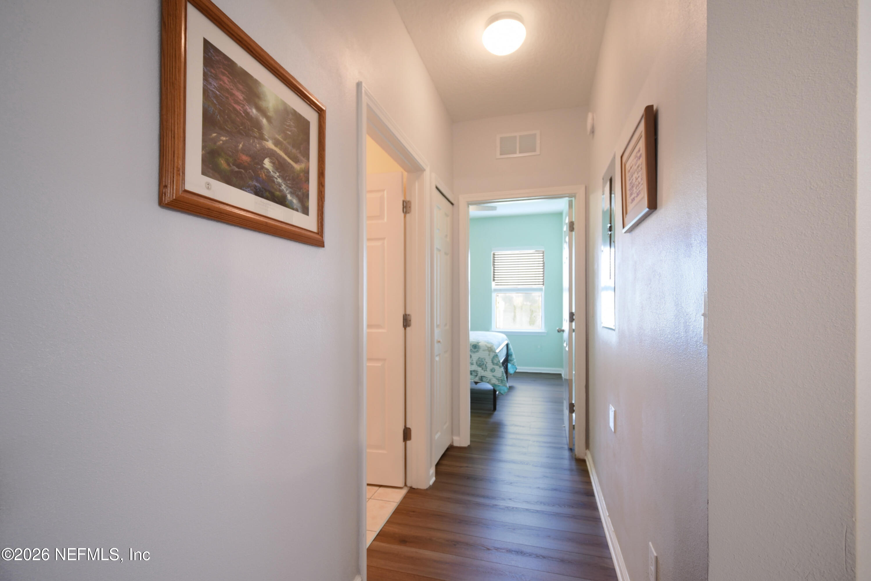 2334 Golden Lake Loop St. Augustine, FL 32084 - Photo 16 of 31 a view of a hallway with wooden floor and a bathroom