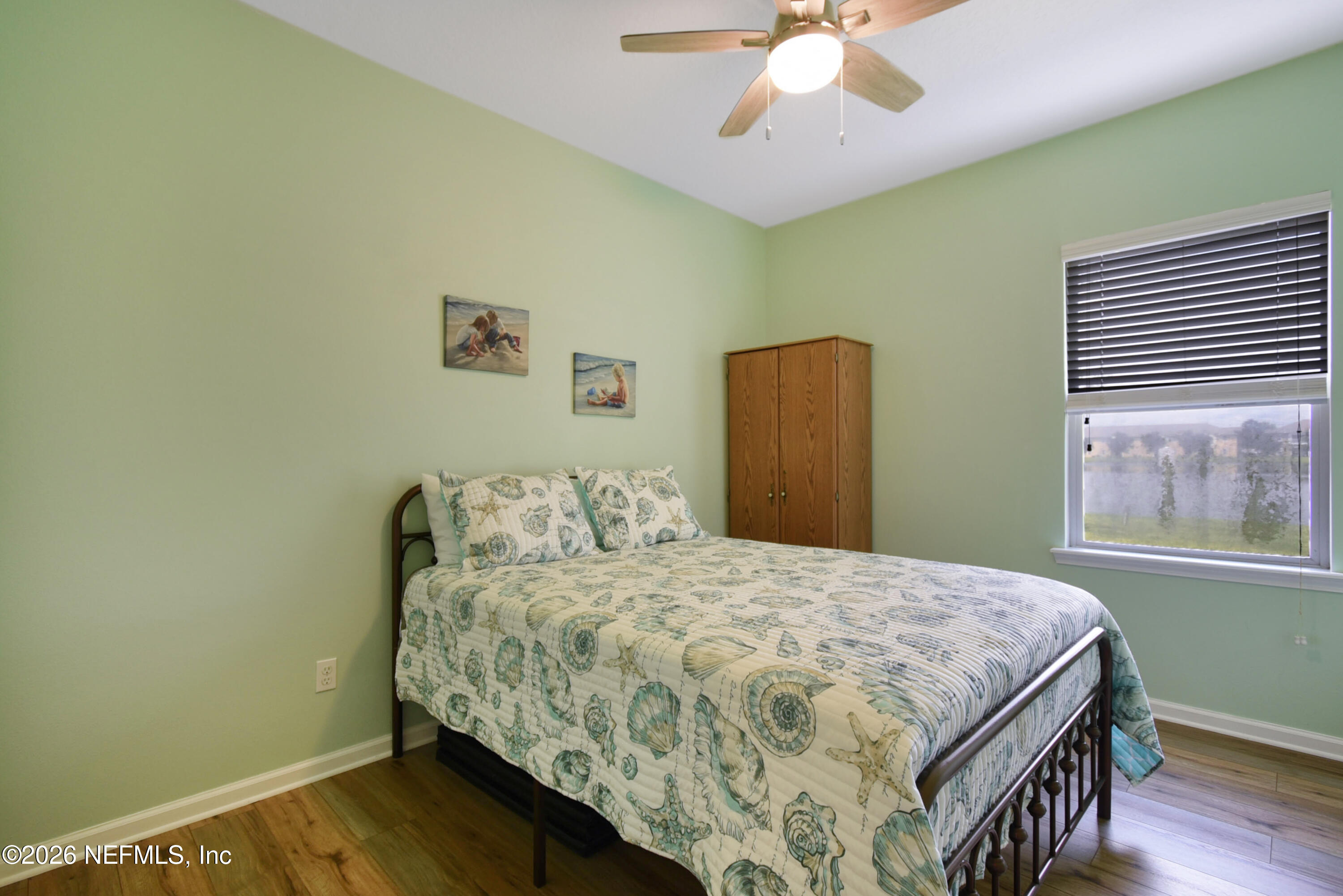 2334 Golden Lake Loop St. Augustine, FL 32084 - Photo 17 of 31 a bedroom with a bed and a chandelier