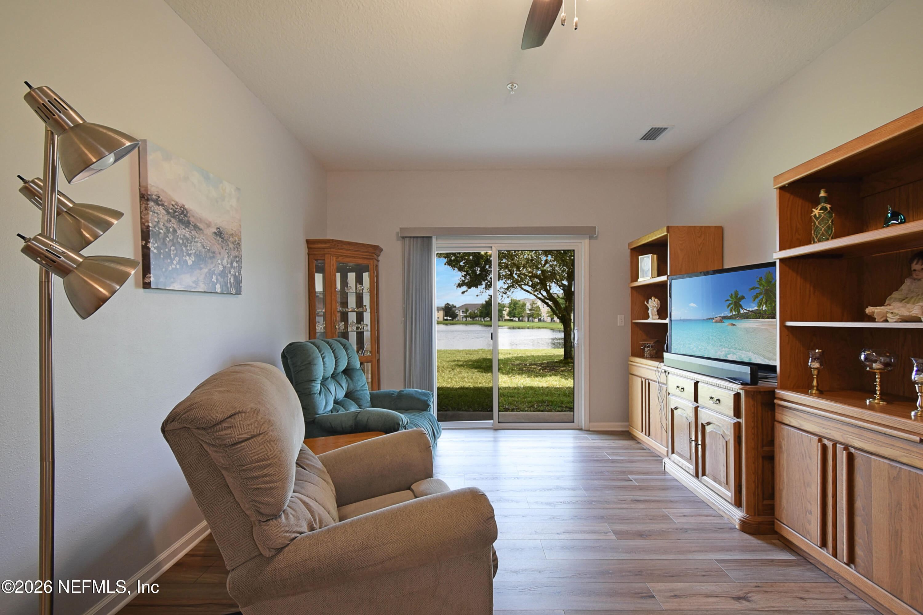 2334 Golden Lake Loop St. Augustine, FL 32084 - Photo 2 of 31 a living room with furniture and a floor to ceiling window