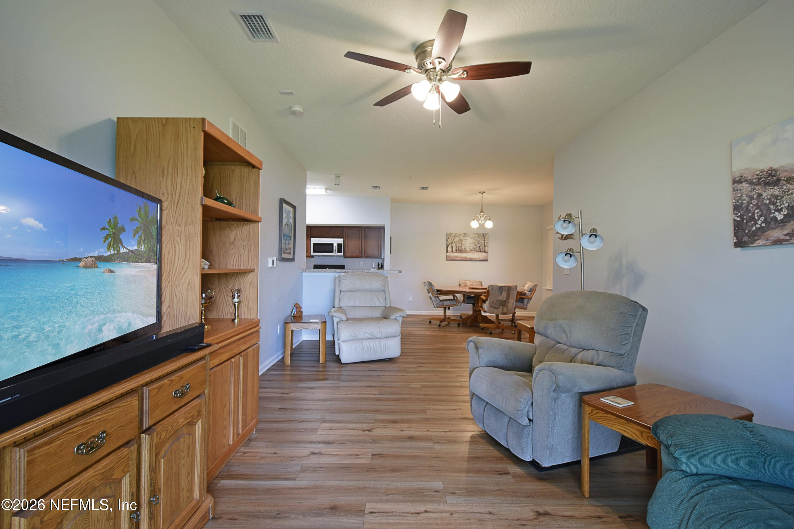 2334 Golden Lake Loop St. Augustine, FL 32084 - Photo 5 of 31 a living room with furniture kitchen view and a flat screen tv
