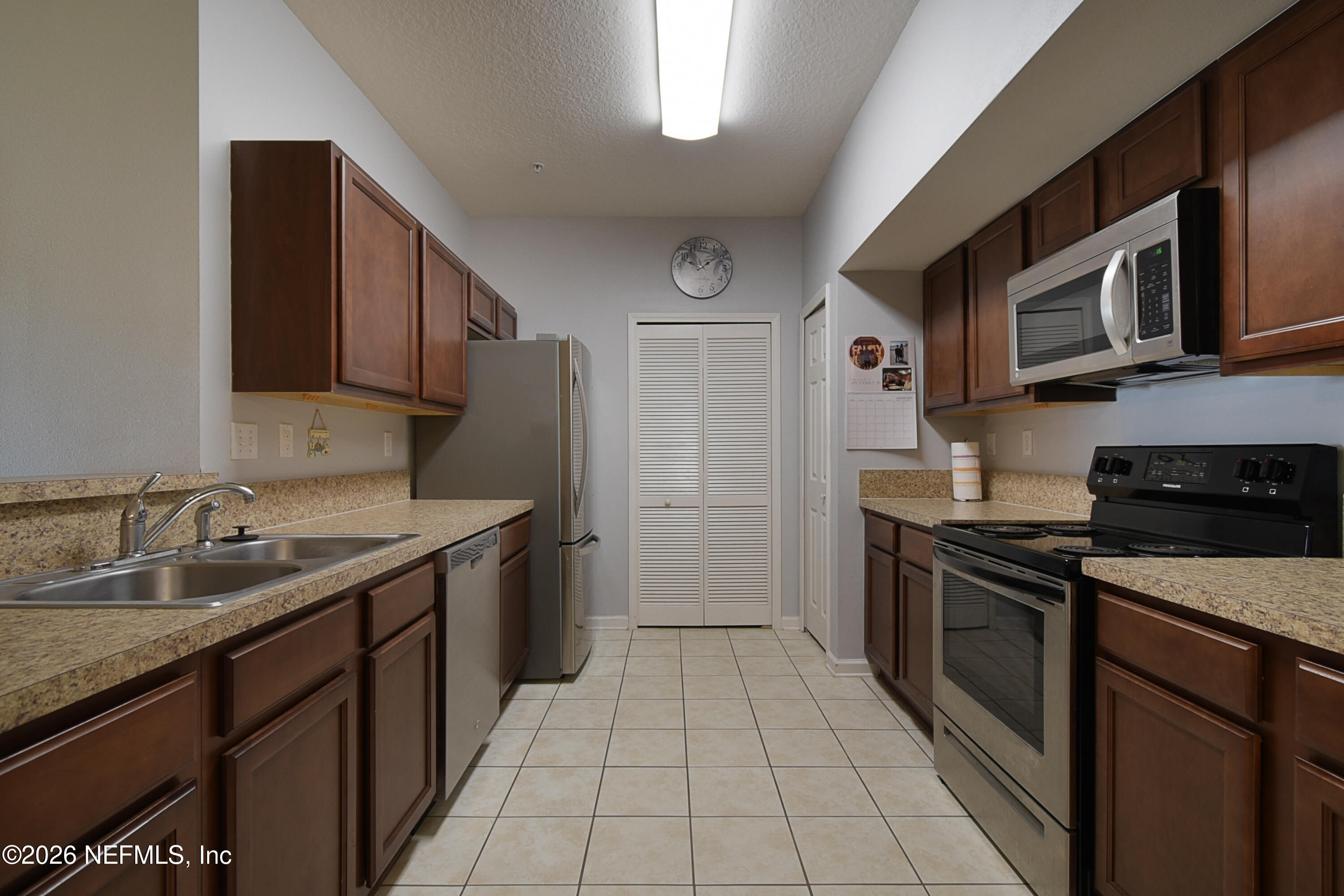 2334 Golden Lake Loop St. Augustine, FL 32084 - Photo 9 of 31 a kitchen with stainless steel appliances granite countertop a sink stove and microwave