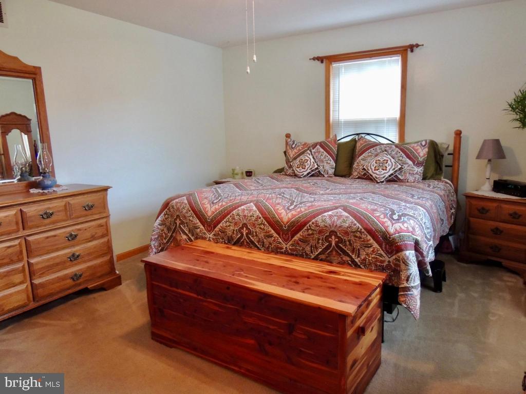 6782 Bent Pine Road Willards, MD 21874 - Photo 13 of 21 a bedroom with a bed and a dresser