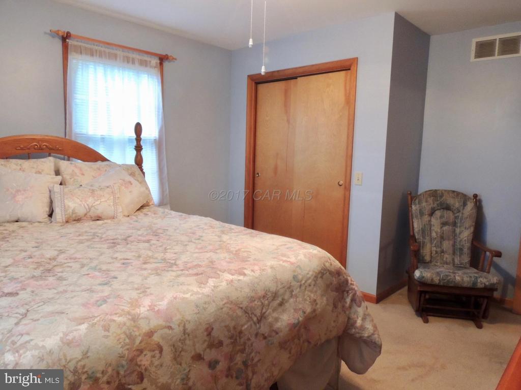 6782 Bent Pine Road Willards, MD 21874 - Photo 15 of 21 a bedroom with a bed and a couch