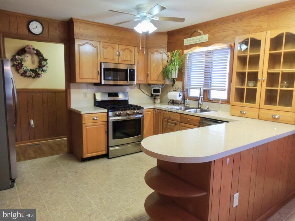 6782 Bent Pine Road Willards, MD 21874 - Photo 5 of 21 a kitchen with a appliances dining table and chairs