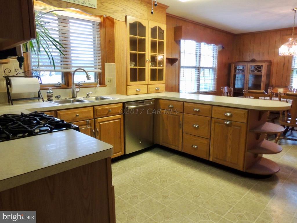 6782 Bent Pine Road Willards, MD 21874 - Photo 6 of 21 a kitchen with a sink stove and cabinets
