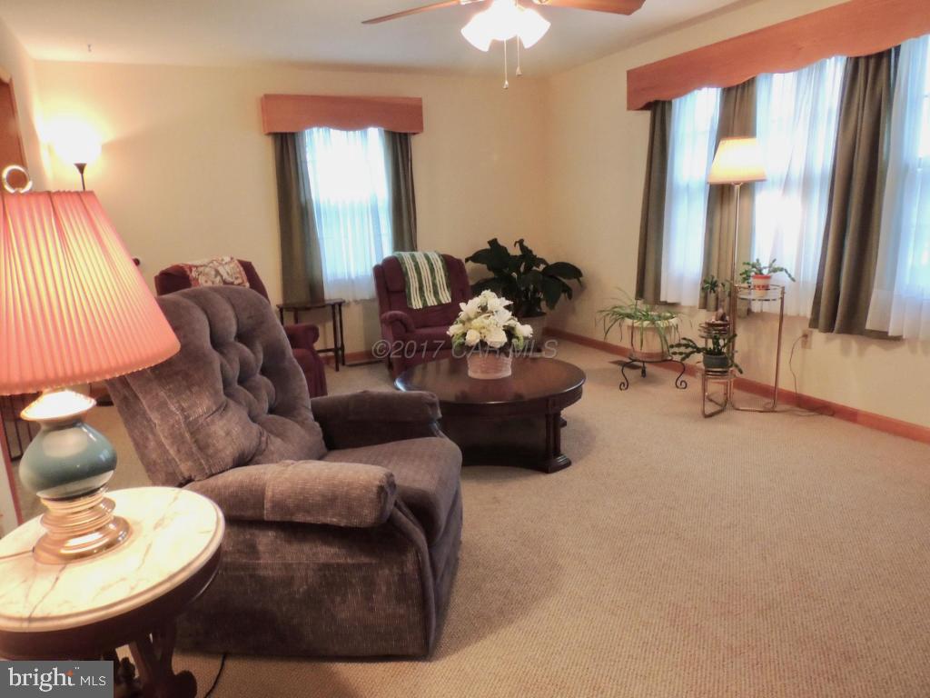 6782 Bent Pine Road Willards, MD 21874 - Photo 10 of 21 a living room with furniture and a large mirror