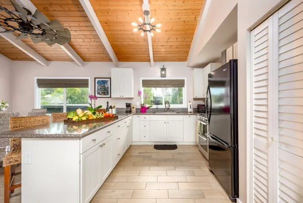 a kitchen with a sink dishwasher refrigerator and cabinets