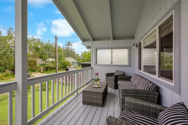 a balcony with furniture and wooden floor