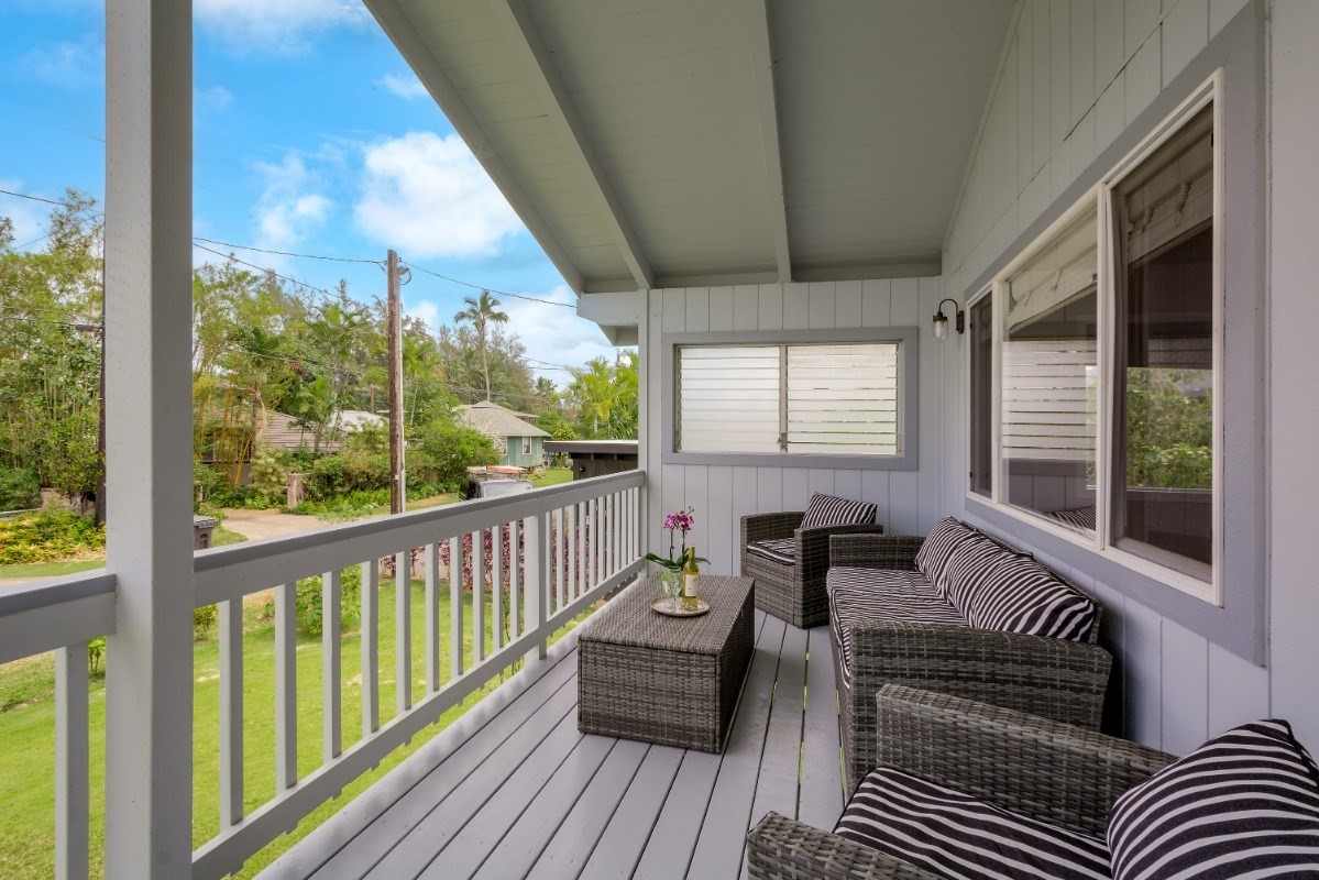 5527 Weke Road Hanalei, HI 96714 - Photo 6 of 28 a balcony with furniture and wooden floor