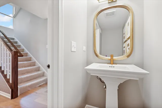 a room with a sink and mirror