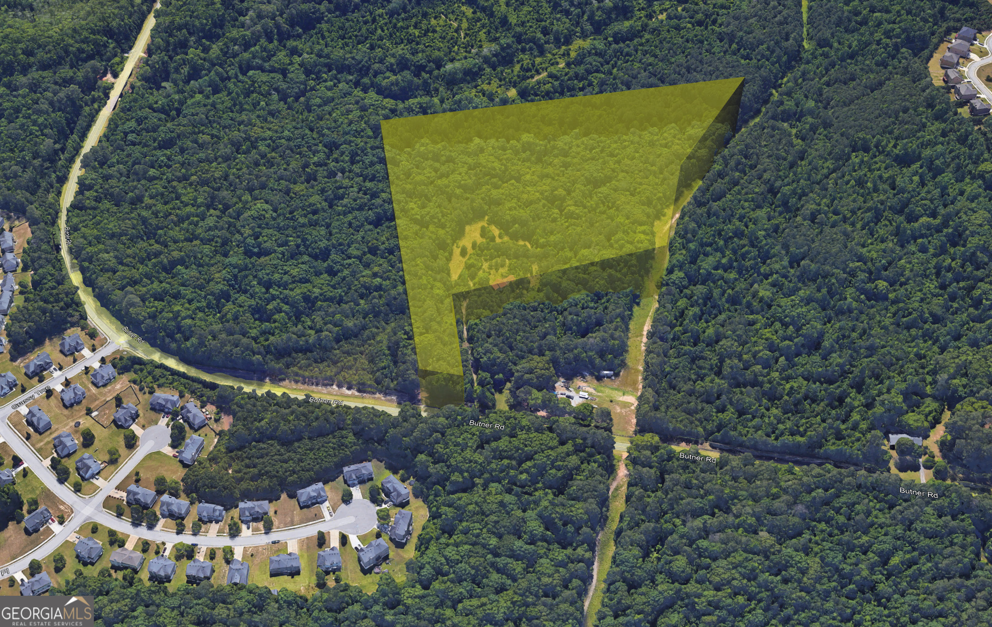 7490 Butner Road Fairburn, GA 30213 - Photo 2 of 9 a sign that is sitting in front of a tree