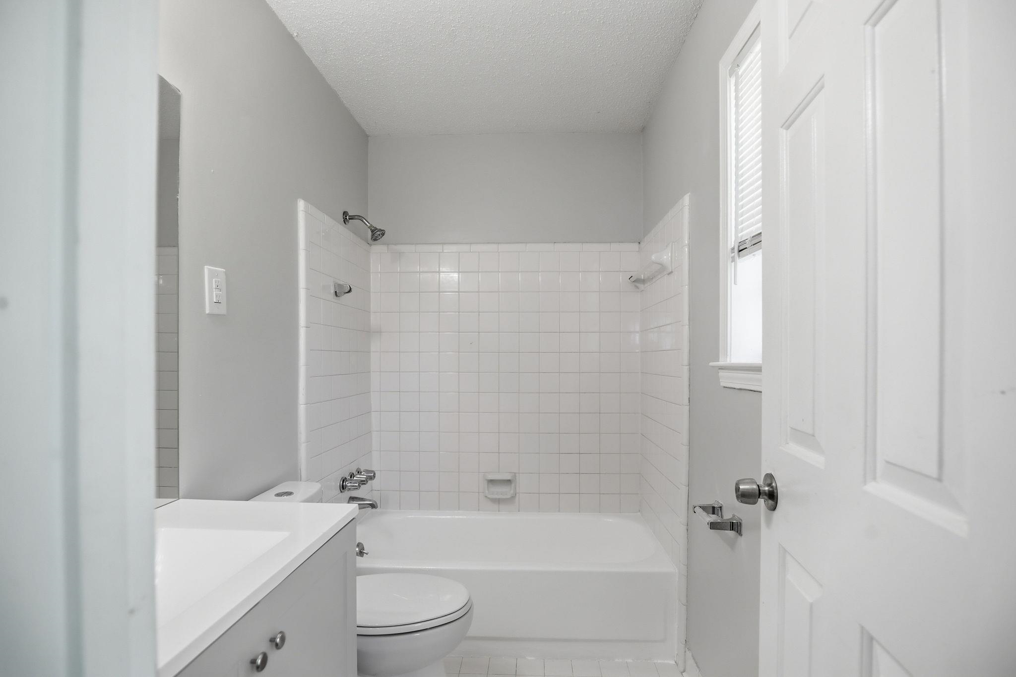 3113 Raleigh Ridge Cove Memphis, TN 38128 - Photo 33 of 38 Bathroom featuring a combination shower and tub with white subway tile surround