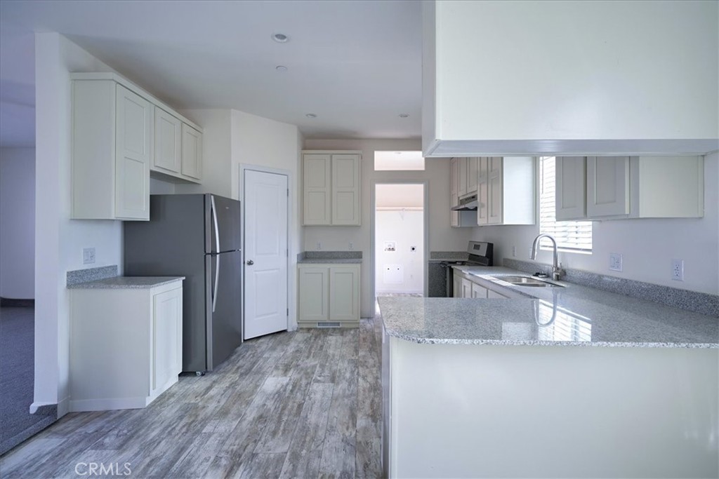 5430 Luna Road Phelan, CA 92371 - Photo 15 of 34 a kitchen with refrigerator and cabinets