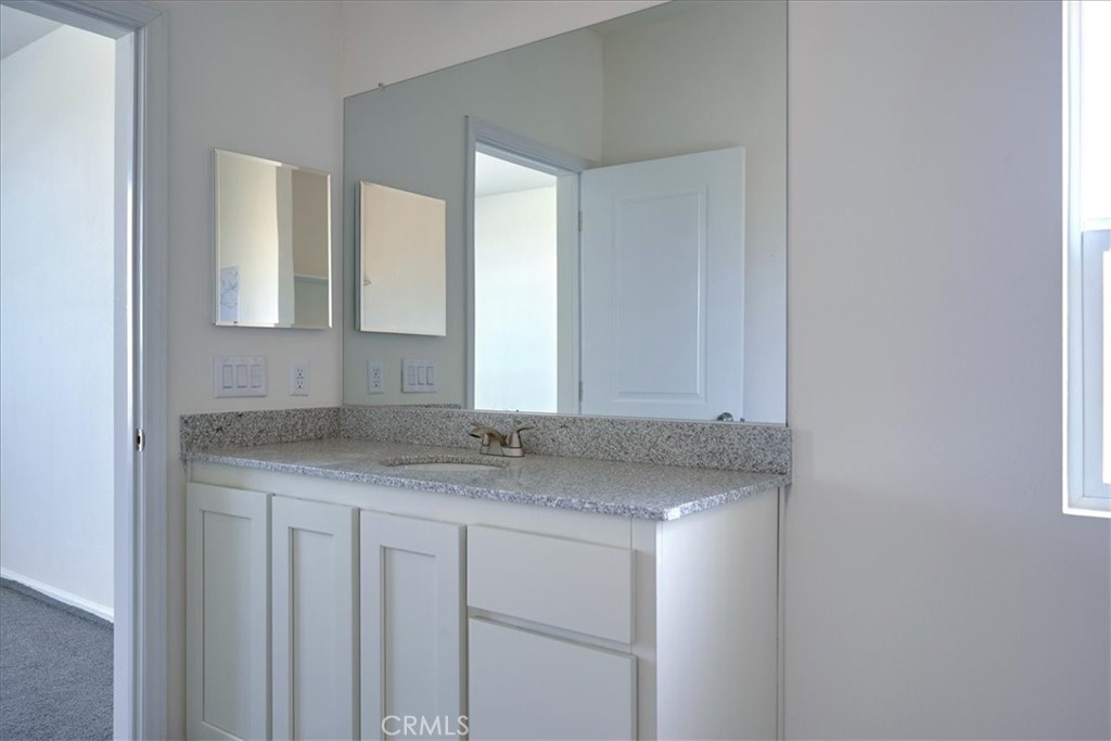 5430 Luna Road Phelan, CA 92371 - Photo 24 of 34 a bathroom with a granite countertop sink and a mirror
