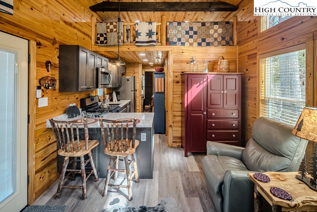 793 Highland Hills Road Newland, NC 28657 - Photo 13 of 40 a view of a dining room with furniture window and wooden floor