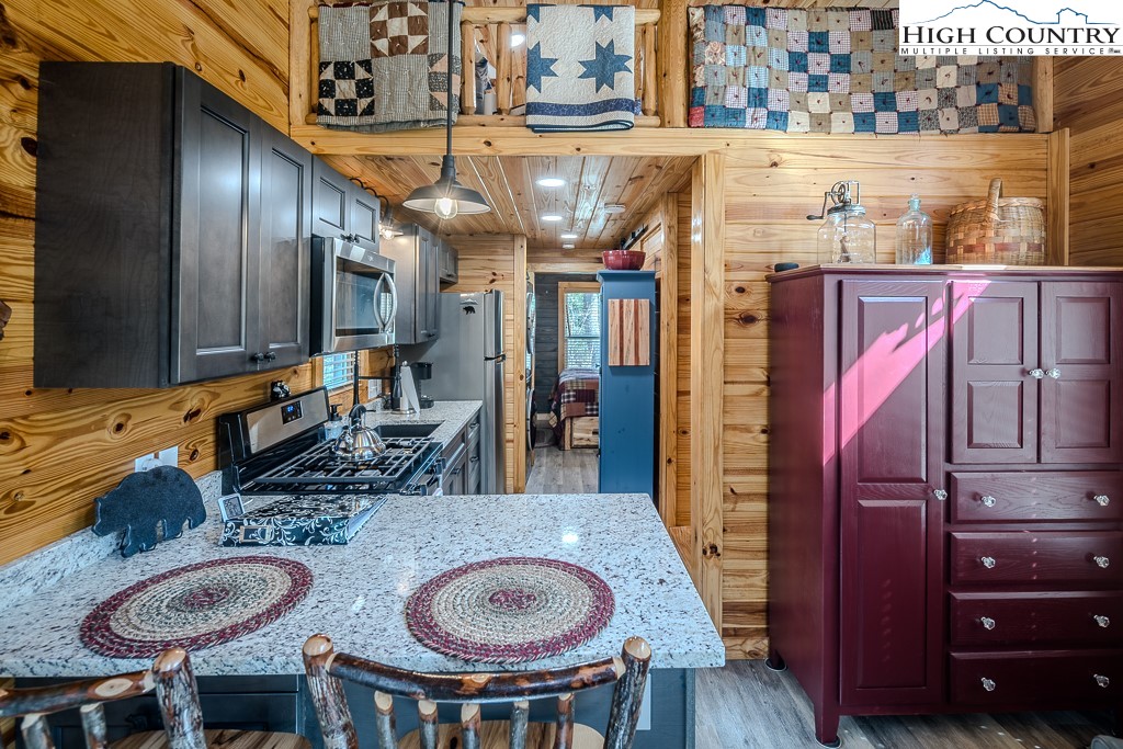 793 Highland Hills Road Newland, NC 28657 - Photo 15 of 40 a dining room with furniture and wooden floor