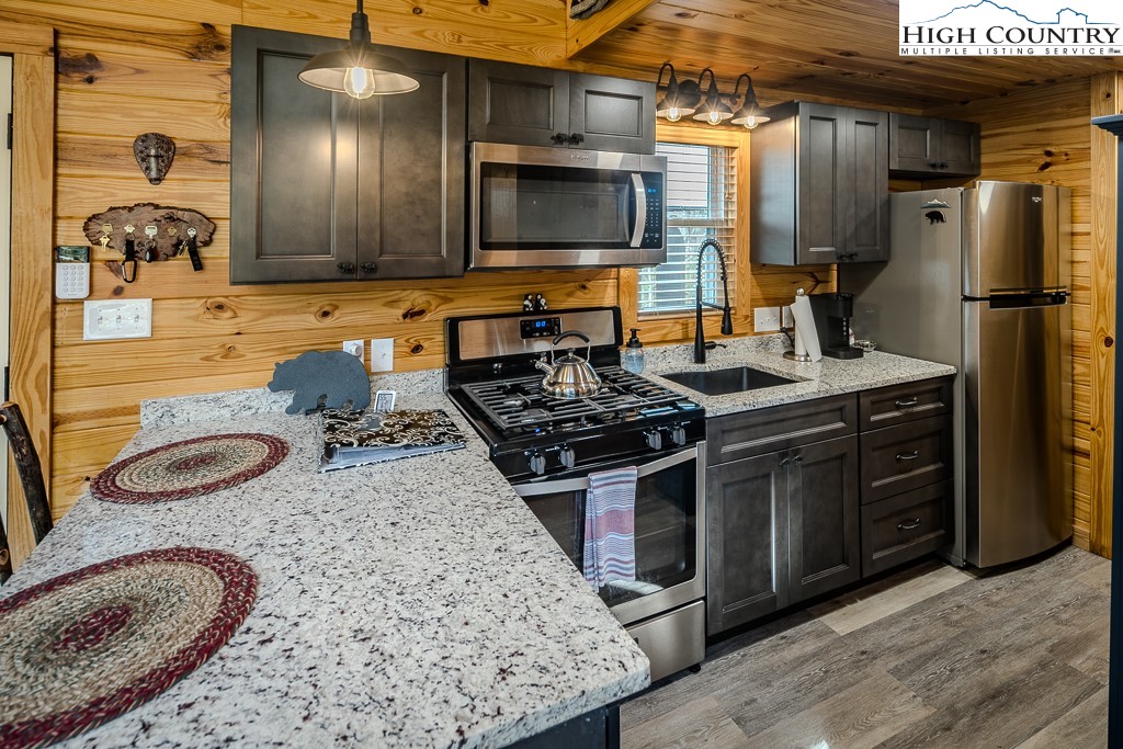 793 Highland Hills Road Newland, NC 28657 - Photo 16 of 40 a kitchen with a sink stove and refrigerator