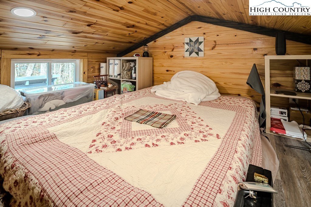 793 Highland Hills Road Newland, NC 28657 - Photo 26 of 40 a view of a bedroom with a bed and furniture