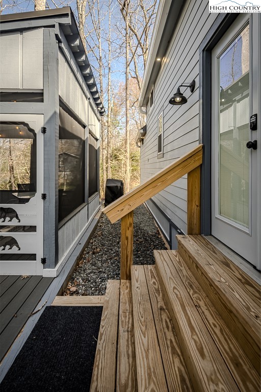 793 Highland Hills Road Newland, NC 28657 - Photo 29 of 40 a view of a balcony with wooden floor and staircase