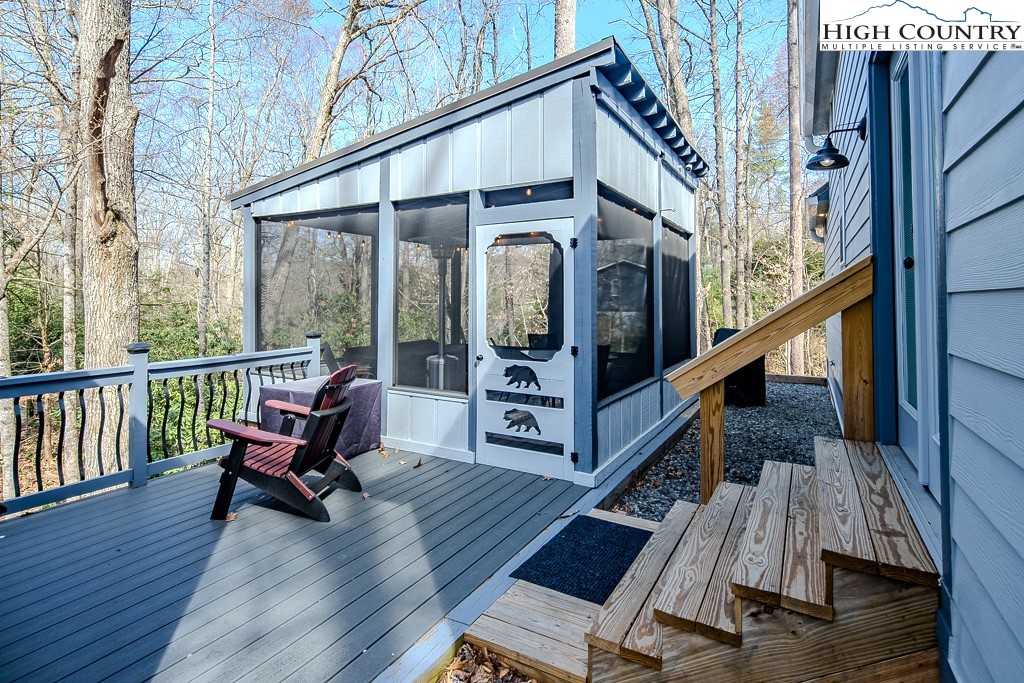 793 Highland Hills Road Newland, NC 28657 - Photo 3 of 40 a view of balcony with wooden floor and furniture