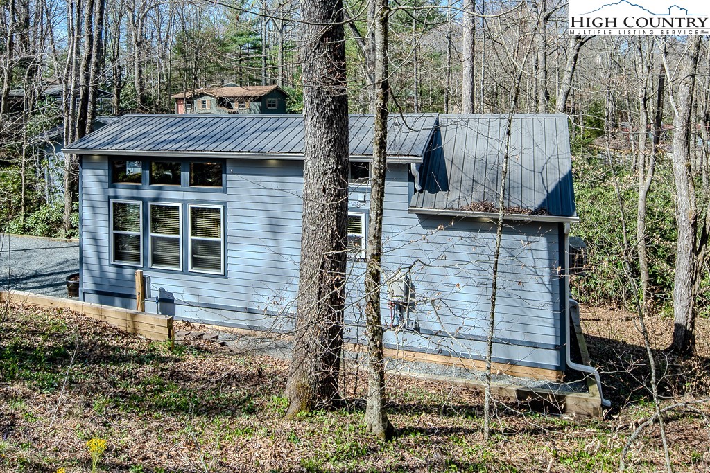 793 Highland Hills Road Newland, NC 28657 - Photo 39 of 40 a view of a house with backyard and sitting area