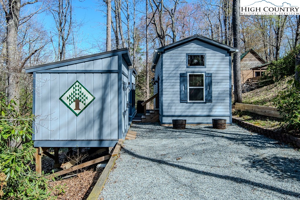 793 Highland Hills Road Newland, NC 28657 - Photo 6 of 40 a view of a small house with a yard