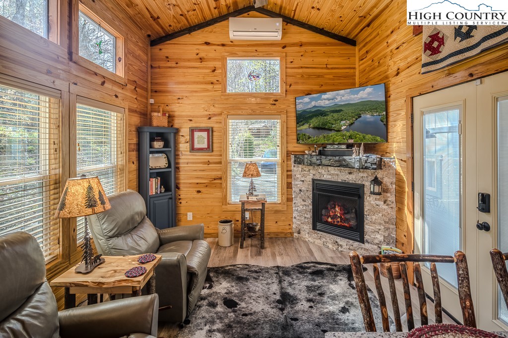793 Highland Hills Road Newland, NC 28657 - Photo 9 of 40 a living room with furniture a flat screen tv and a fireplace