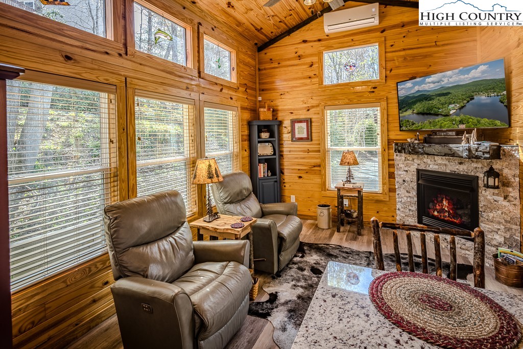 793 Highland Hills Road Newland, NC 28657 - Photo 10 of 40 a balcony with furniture and a fireplace