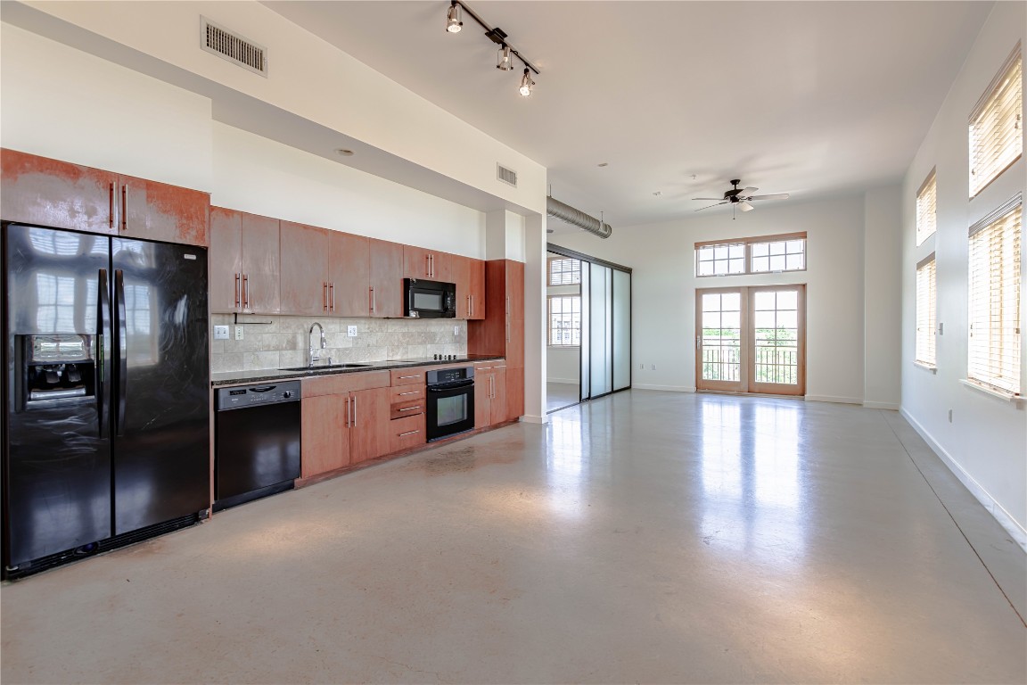 2235 East 6th Street, Unit 404 Austin, TX 78702 - Photo 2 of 37 a kitchen with stainless steel appliances granite countertop a refrigerator a sink a stove and oven