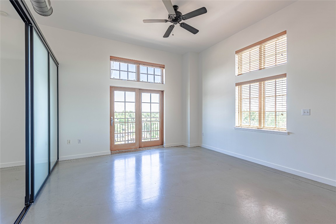 2235 East 6th Street, Unit 404 Austin, TX 78702 - Photo 3 of 37 a view of an empty room with a window and wooden floor